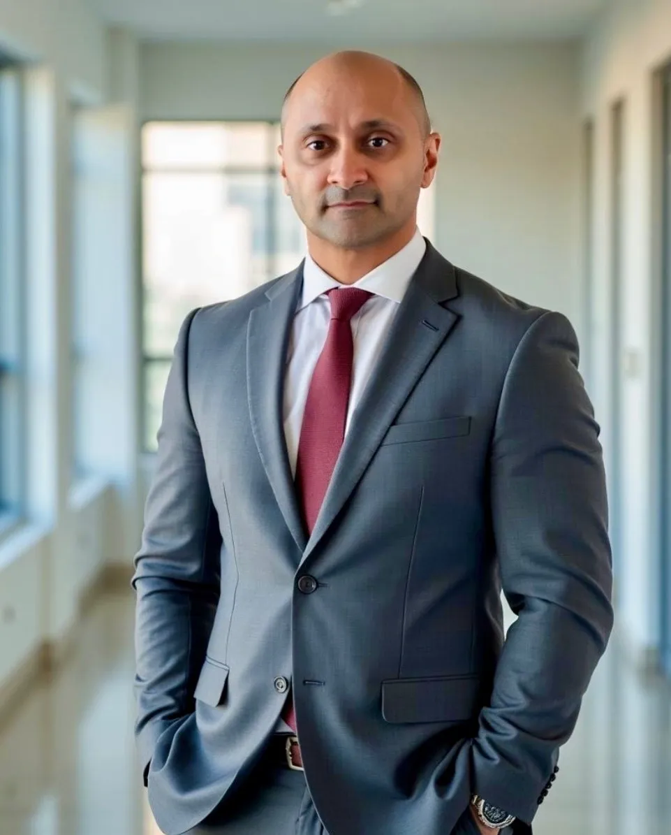 Businessman in gray suit standing in hallway