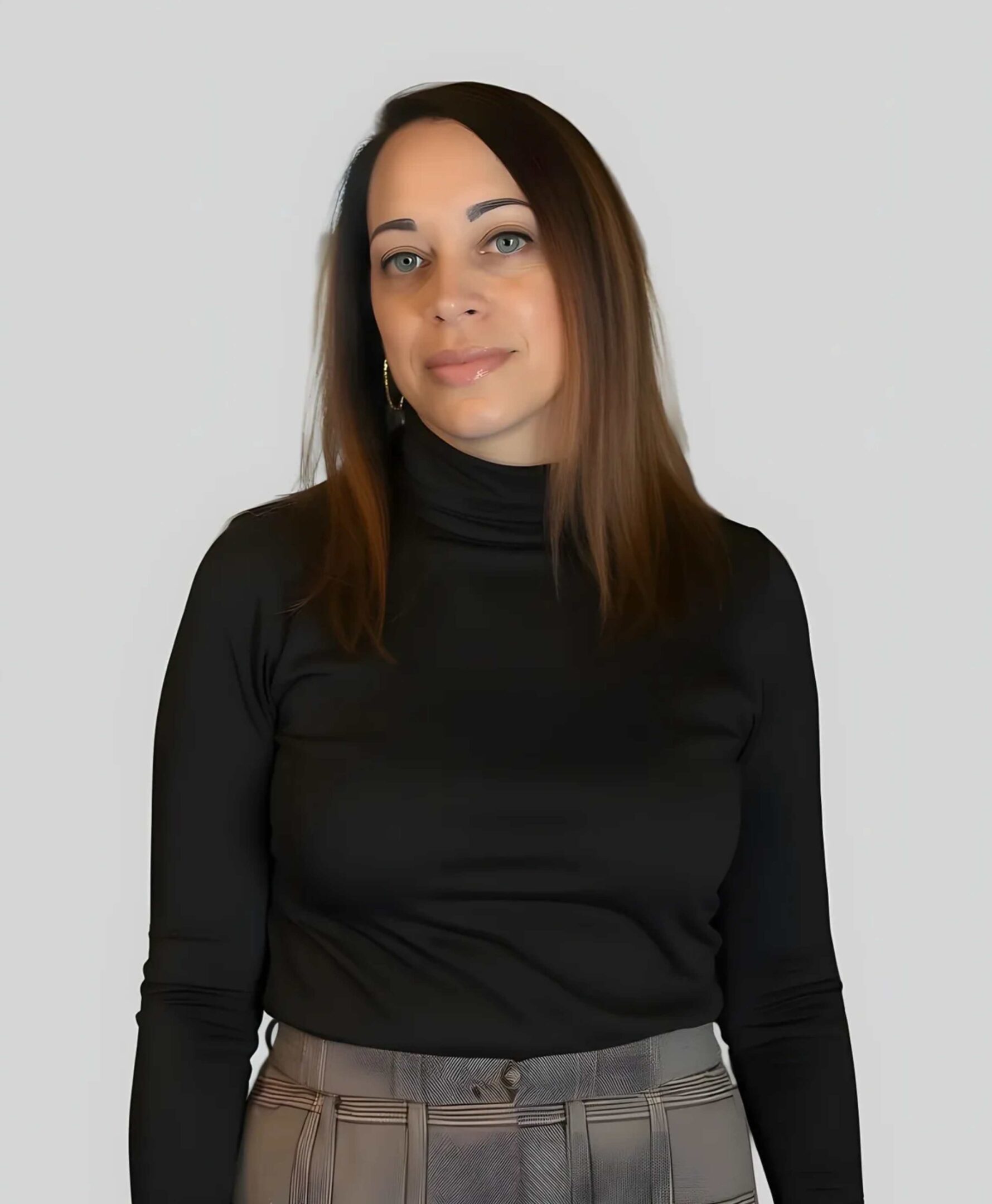Woman in black turtleneck and checkered pants.