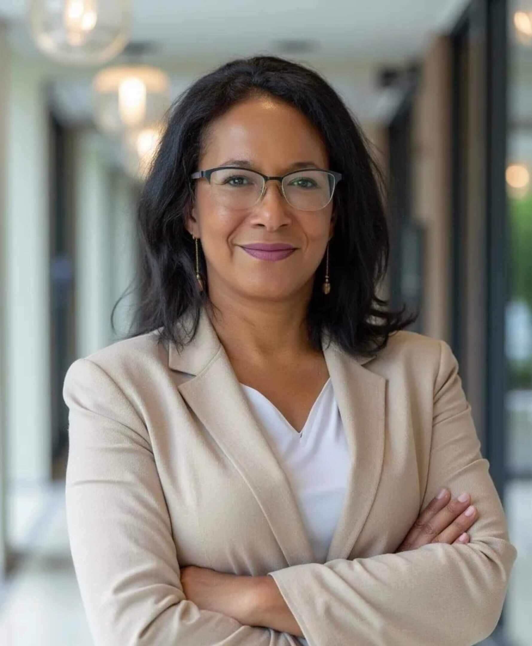Confident professional woman with glasses, arms crossed