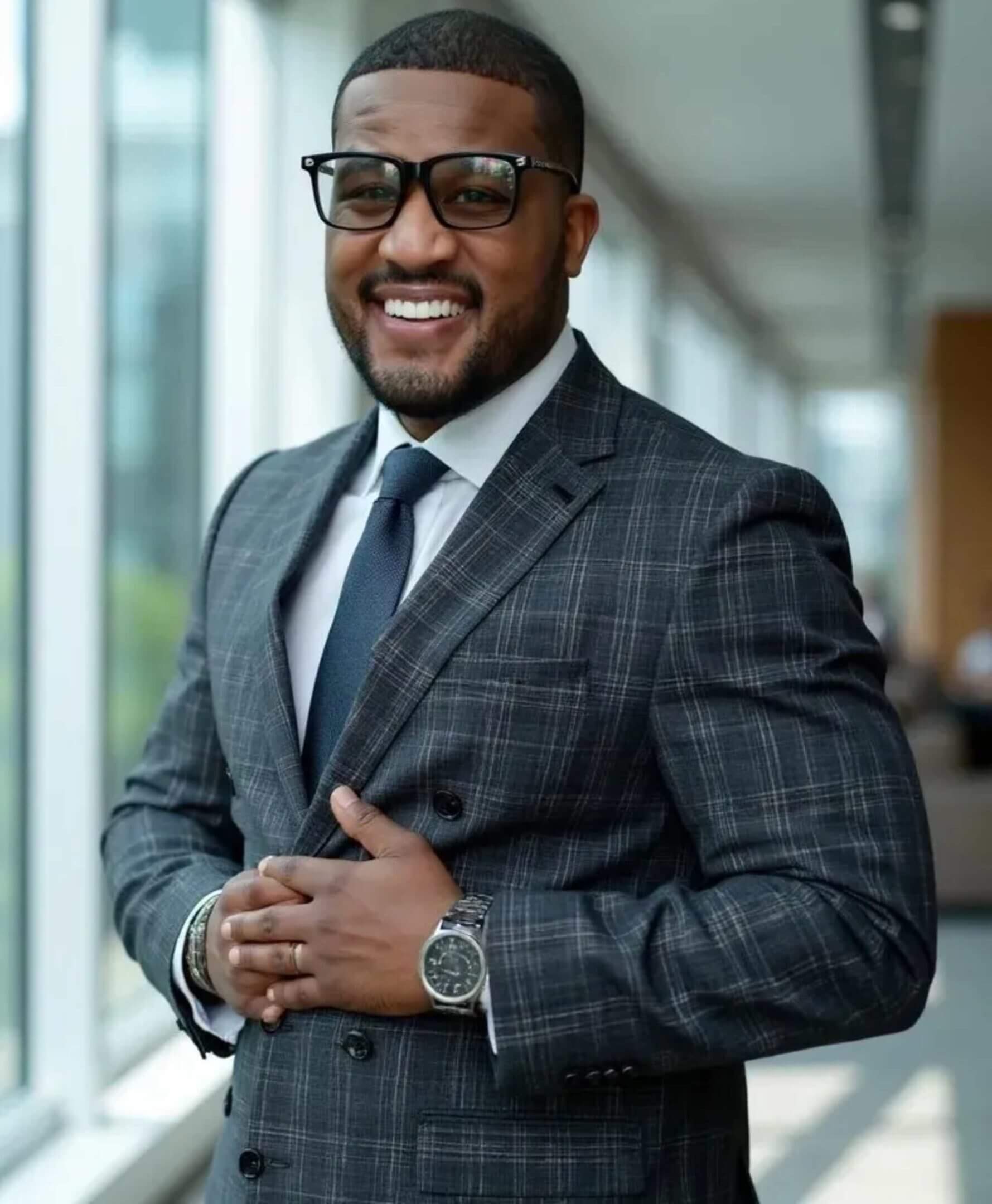 Smiling businessman in plaid suit and glasses