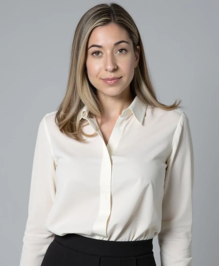 Woman in white blouse, neutral background.