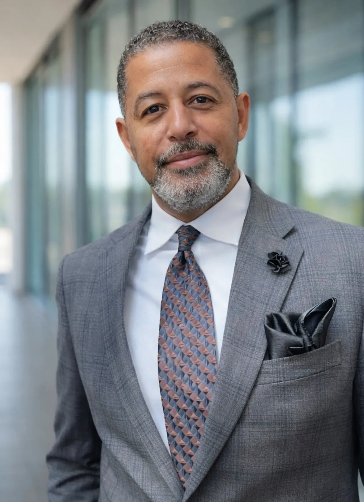 Confident executive in gray suit with pocket square