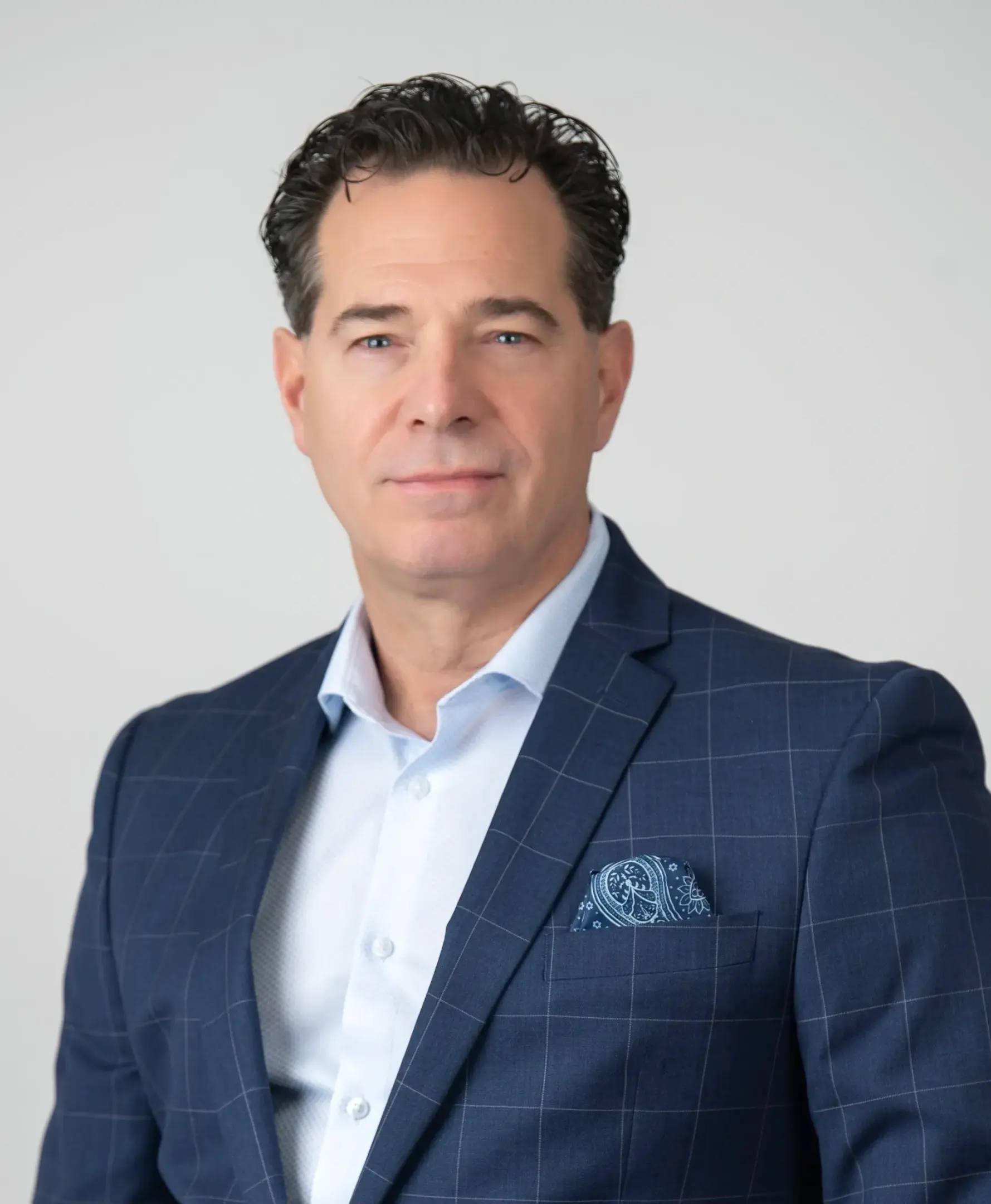 Businessman in blue checked suit with pocket square