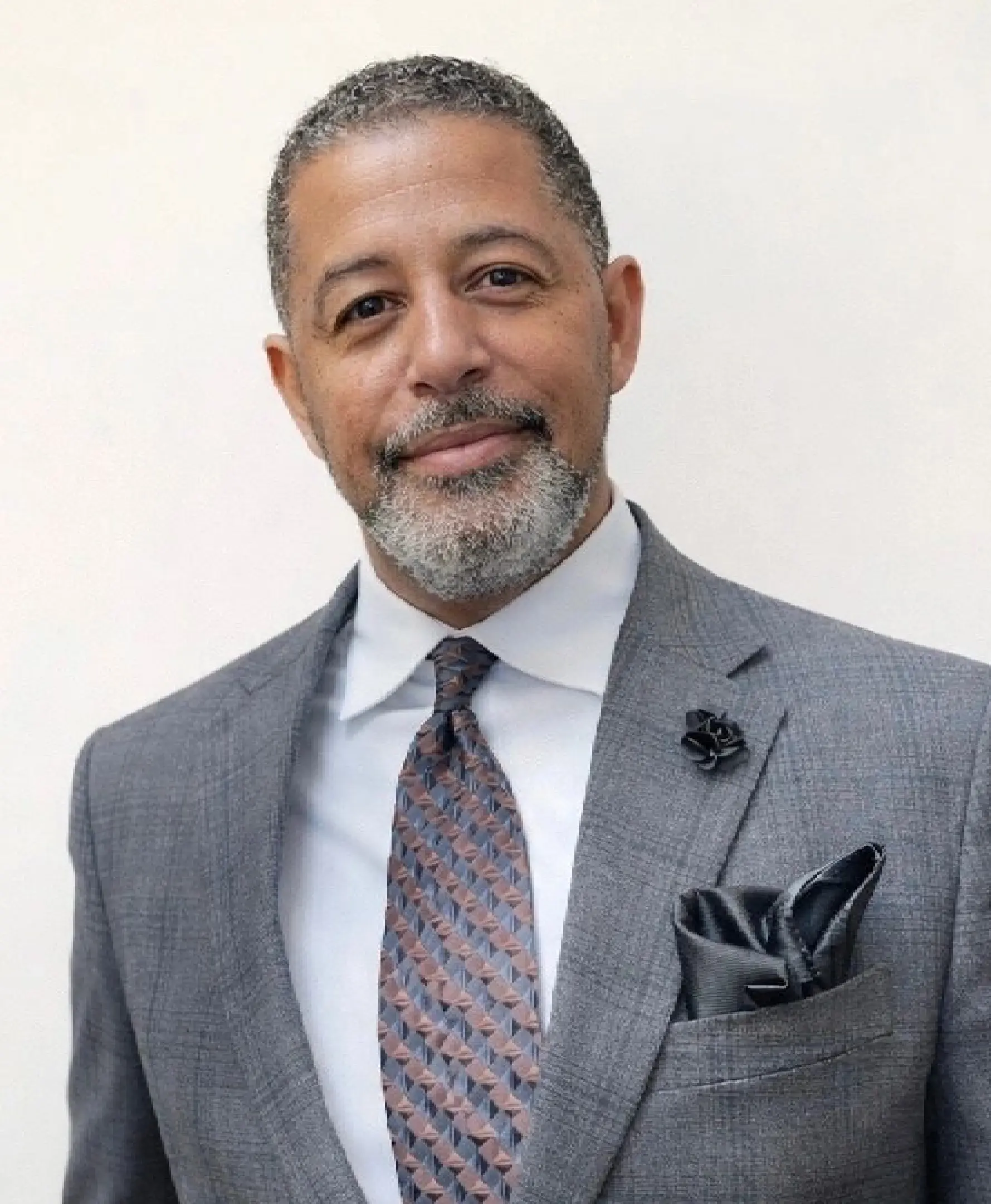 Smiling man in gray suit and patterned tie